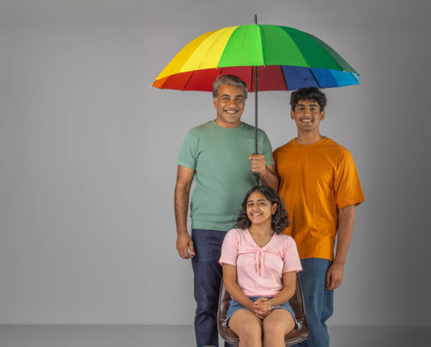 istock Father with children holding umbrella over white background 1636205723