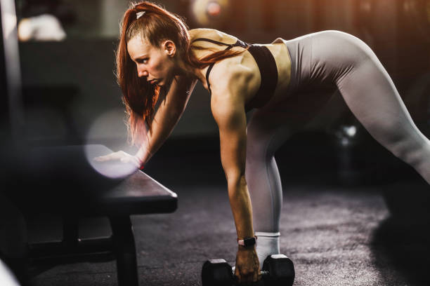 istock Woman Doing Back Exercise At The Gym 1636236771