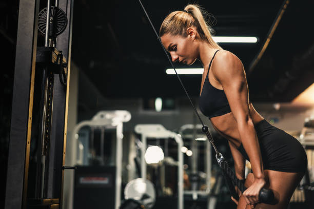 istock Woman Doing Training On Machine For Her Triceps Muscle At The Gym 1636239406