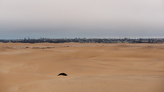 Wide-angle view over the beautiful Namib Desert and city of Swakopmund in the distance, Namibia
