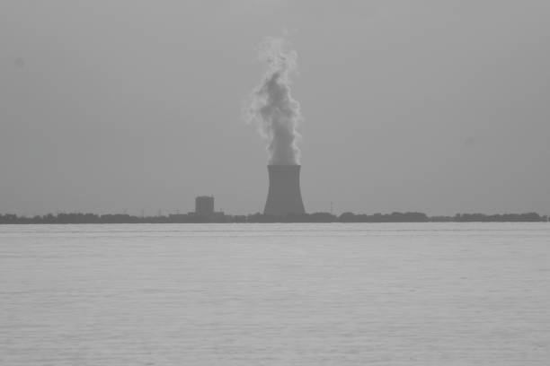 Big chimneys with white smoke in winter sunny day near nuclear power plant in Temelin CZ 02 04 2025