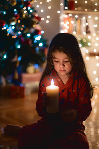 istock Little girl holding Christmas lights 1636254949