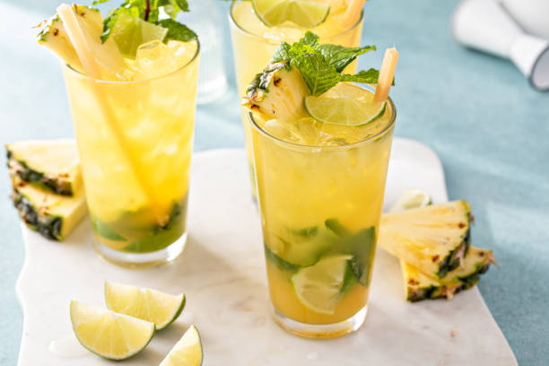 istock Pineapple mojito with limes and mint and a slice of pineapple 1636263678