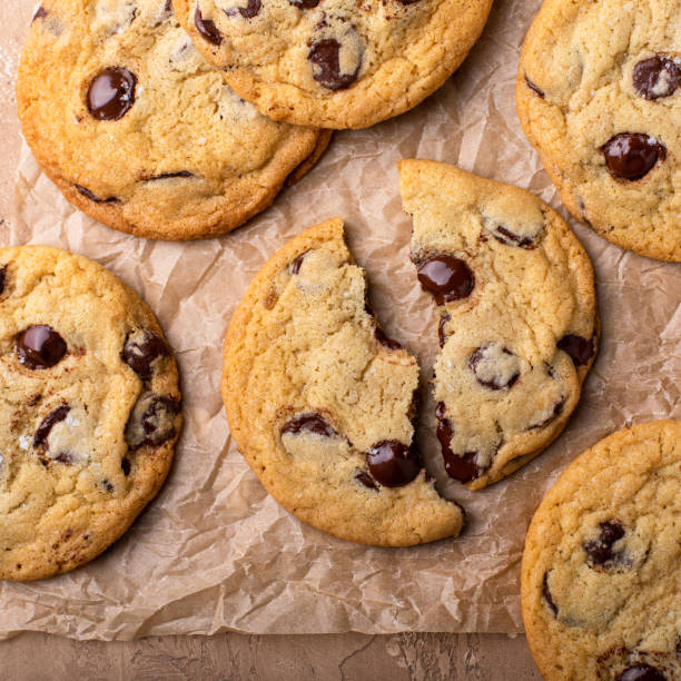 istock Chocolate chip cookies with flaky salt on parchment paper 1636264811