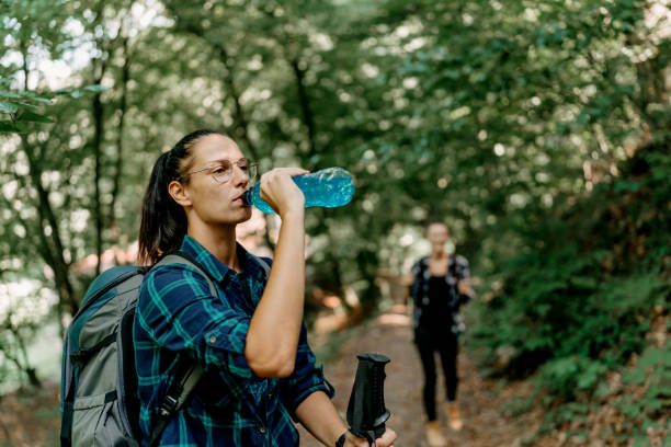 istock Woman sips water to stay refreshed on her invigorating hike 1636284605