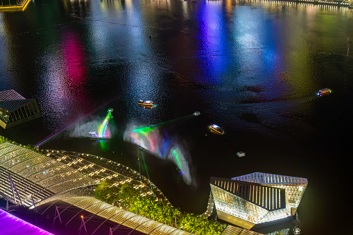 Singapore, Singapore, September 12th, 2016. Laser show at night at the Marina Bay, aerial view with the reflections of the financial districts buildings in the background