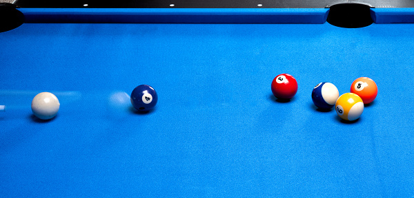 Billiard balls on a blue pool table