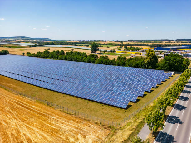 istock Solar power plant with solar panels next to a road in rural area 1636354721