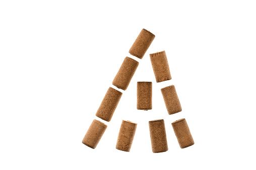 Wine corks in the shape of a Christmas tree on a white background. Top view, flat lay.