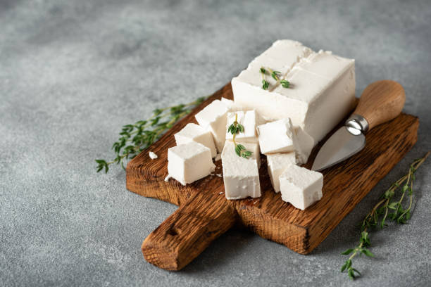 istock Festa cheese cubes, gray concrete background. Side view, selective focus. 1636361294
