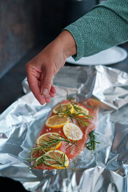 istock Preparing Salmon Fish Fillet with Lemon and Rosemary 1636376848