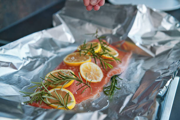 istock Preparing Salmon Fish Fillet with Lemon and Rosemary 1636376853