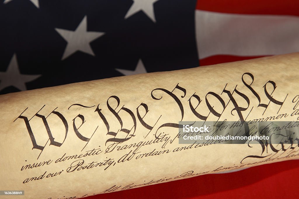 US Constitution US Constitution sitting on an American flag Founding Fathers of the United States Stock Photo