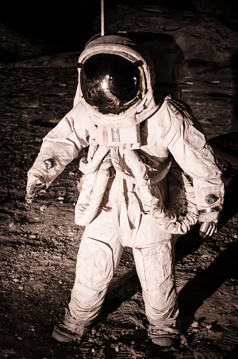 Reenactment of the moon landing during an Apollo mission. Non identifiable model, no model release necessary. Nikon D7000, Nikkor 16-85mm. Strong blur and high grain cause of bad light condition. Soft vintage edit.