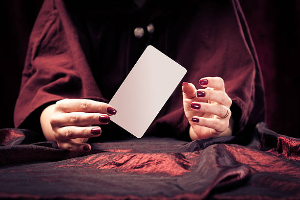 fortune teller's hands fortune teller with with blank tarot card - easily add your own message or design. fortune teller photos stock pictures, royalty-free photos & images