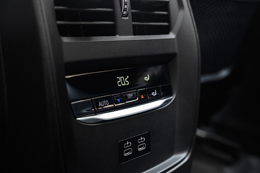 Rear climate controls and USB-C charge ports in a modern car.