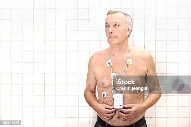 Senior Wearing Heart Monitor Stock Photo - Download Image Now - Patient, Remote Control, Surveillance