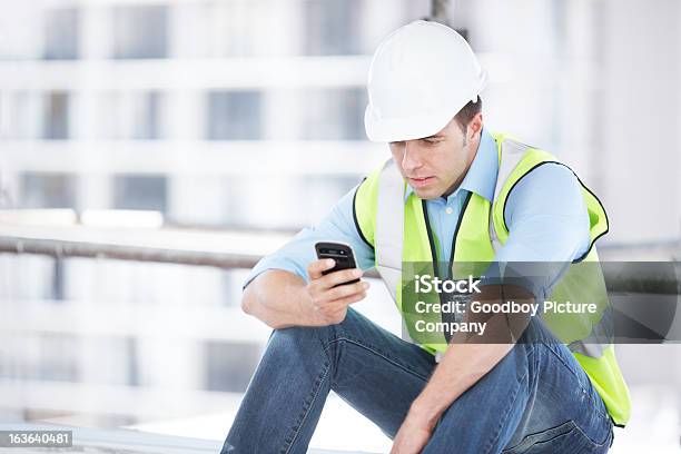 Modern Technology Keeping You In The Know Stock Photo - Download Image Now - Construction Worker, Mobile Phone, Adult