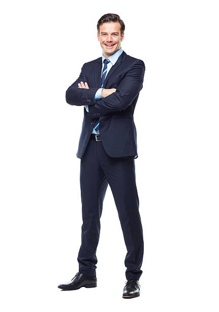Ready for anything in the corporate world! A full length studio portrait of a handsome and young business executive isolated on white arms crossed stock pictures, royalty-free photos & images