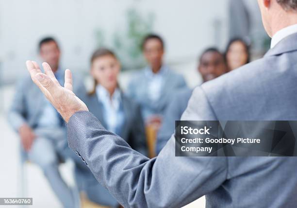 Holding Their Attention Stock Photo - Download Image Now - Gesturing, Men, Office