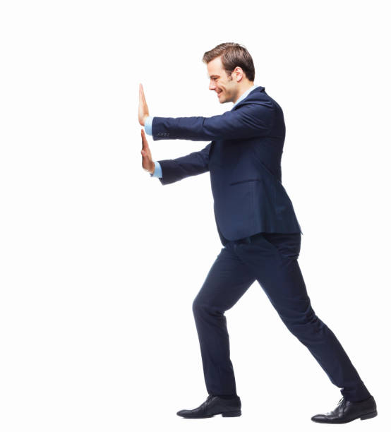 Smiling businessman pressing against a white board - copyspace