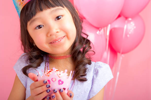 istock Young girl holding a cupcake 163641527