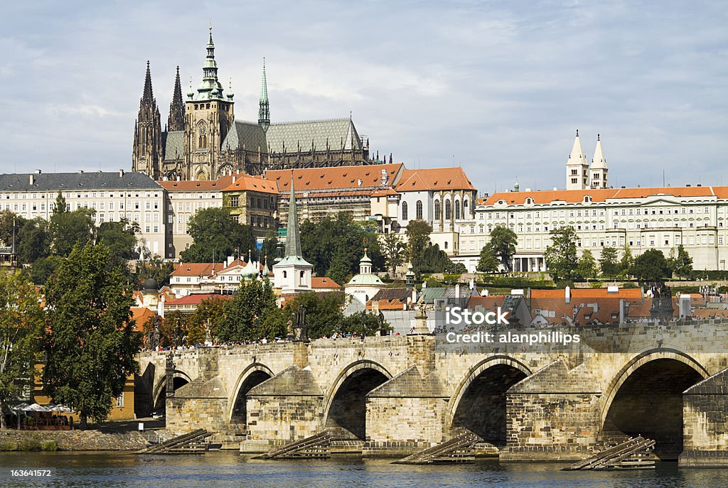 Charles Bridge and Saint Vitus Cathedral in Prague View of Saint Vitus Cathedral and Charles Bridge in Prague. This beautiful Gothic cathedral dominates the skyline in the popular tourist destination of the Czech Republic. Hradcany Castle Stock Photo