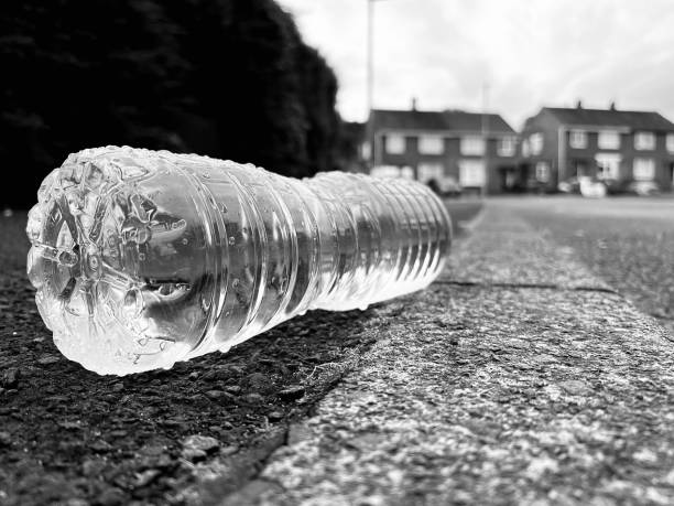 istock Discarded plastic water bottle on the street 1636419302