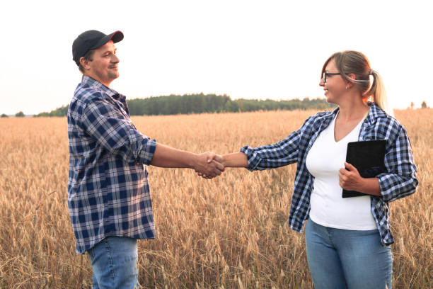 istock At the end of a grain purchase transaction, people shake hands while standing in a wheat field at sunset. Agriculture and small business. Two people are discussing the agricultural business. 1636420932