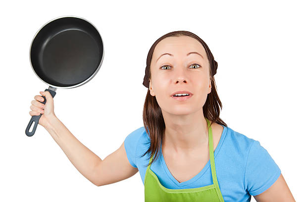 istock angry woman with frying pan 163642448