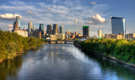 A scene of the Philadelphia , Pennsylvania skyline and the Schuylkill River on a bright summer day.