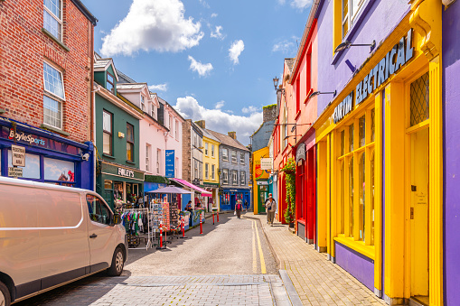 Narrow streets of brightly colored shops and cafes in the historic center of the small fishing port town of Kinsale, in Cork County Ireland.