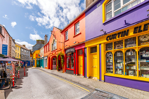 Narrow streets of brightly colored shops and cafes in the historic center of the small fishing port town of Kinsale, in Cork County Ireland.