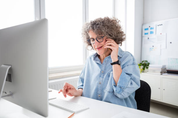 istock Mature woman working in the office 1636474240
