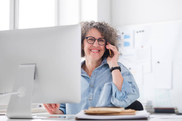 istock Mature woman working in the office 1636474810