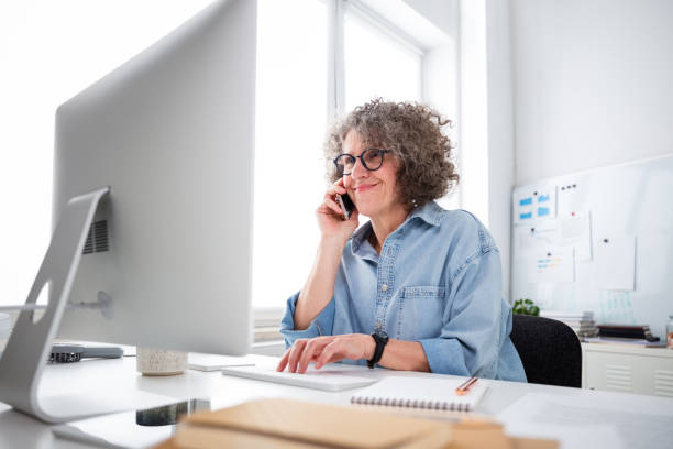 istock Mature woman working in the office 1636475341