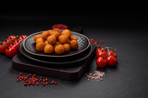 istock Delicious fried potato balls with breaded mozzarella, salt, spices and herbs 1636476466