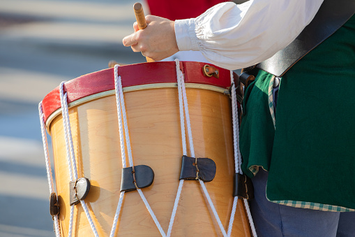 An historical colonial America drummer playing percussion.
