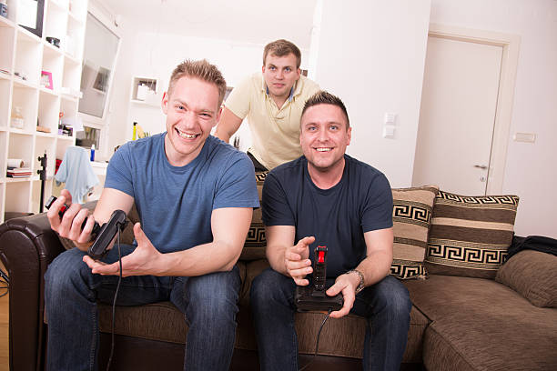 istock Men playing video games at home 163650152