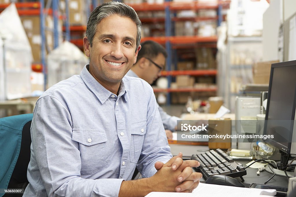 Uomo d'affari che lavorano alla scrivania In magazzino - Foto stock royalty-free di Deposito