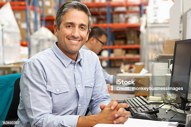 Businessman Working At Desk In Warehouse Stock Photo - Download Image Now - Warehouse, Office, Dispatcher