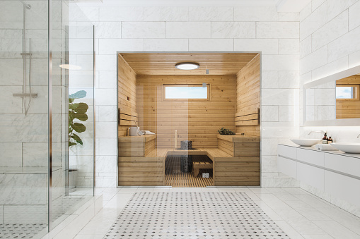 Wooden sauna in a modern luxurious bathroom.
