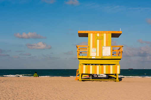 Miami Beach, Florida, United States - February 9, 2021: View from South Pointe Pier of the beach and the colorful and novel observation posts of the lifeguards on a sunny morning in South Beach, Florida.