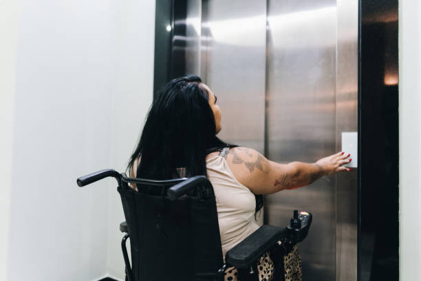 istock Wheelchair mature woman waiting elevator 1636512802