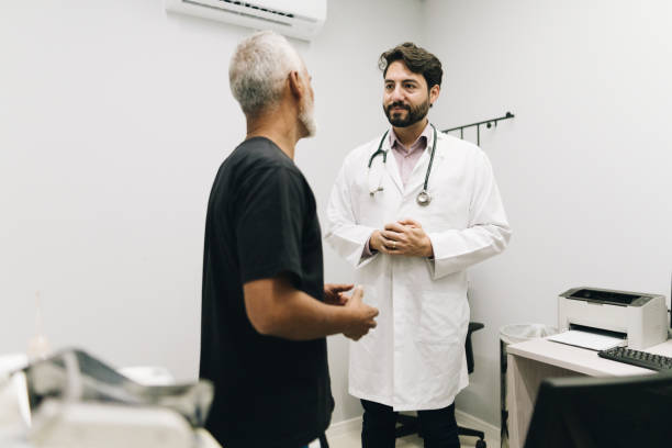 istock Doctor talking with his patient on a doctor's office 1636513390