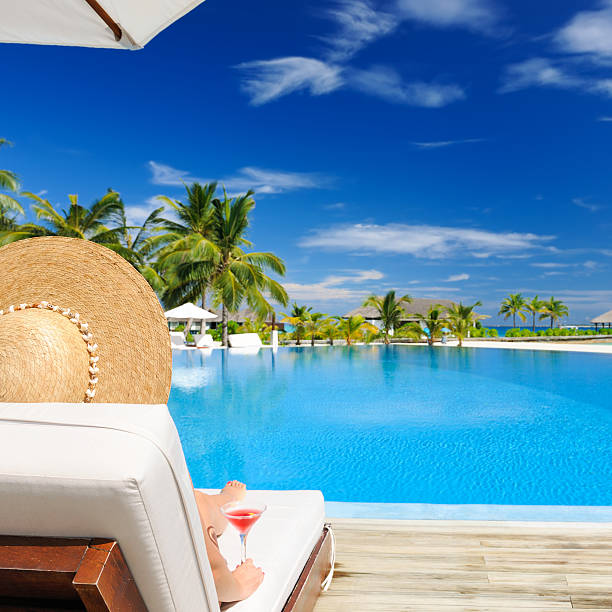istock Woman at poolside with cosmopolitan cocktail 163652278