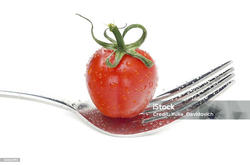 Tomate cherry en un tenedor aislado - Foto de stock de Comida vegetariana libre de derechos