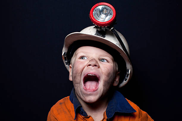 Young boy in coal miner hard hat and safety clothing stock photo