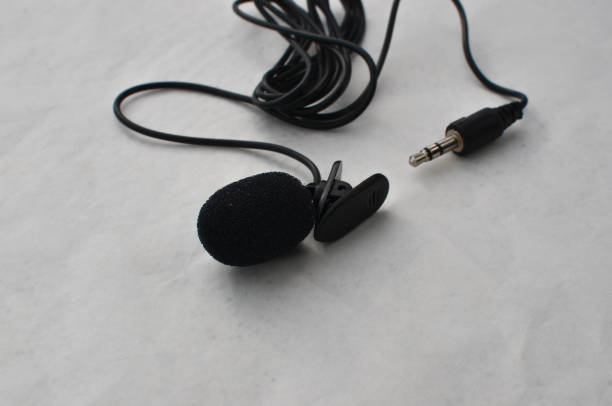 istock Professional lavalier microphone close-up, perfect for high-quality audio recording. Precise and professional audio recording and production concept. 1636542097