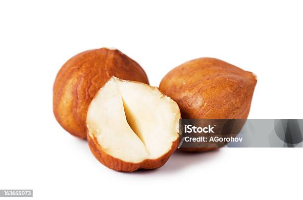 2 Whole Hazelnuts And 1 Half Hazelnut On A White Background Stock Photo - Download Image Now